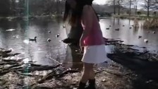 Cute Asian teen dances around the duck filled pond